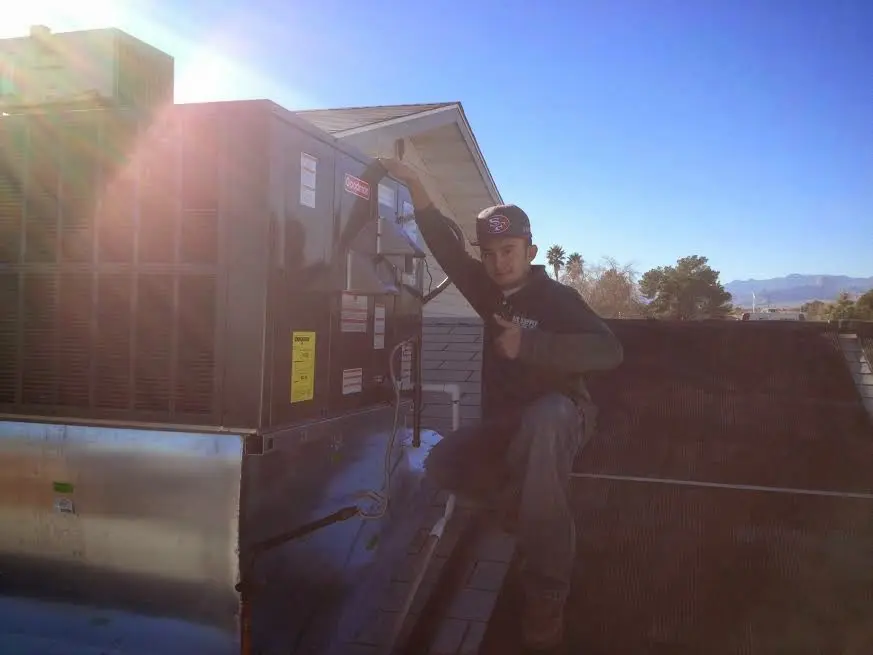 HVAC technician performing Boiler Repair on a rooftop unit in Eucalyptus Hills